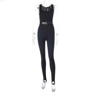 Detail of a slim-fit black sleeveless jumpsuit featuring a waist belt with a gold buckle