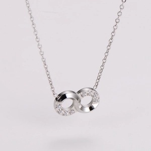 Detailed view of silver infinity necklace pendant set with sparkling clear zircons