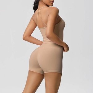 Macro shot of nude backless sports romper featuring criss-cross straps and sleek fit
