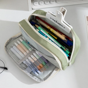 Detail view of large capacity canvas pencil case with organized mesh pockets and pen slots