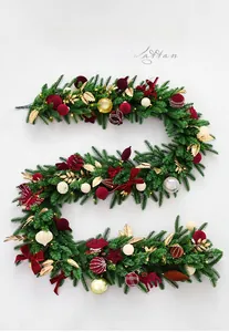 Detail of 2.7m green Christmas rattan with red velvet balls and warm LED lights