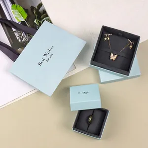 Light blue jewelry gift set with necklace box, ring box, and 'Best Wishes' paper bag