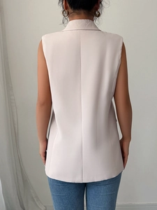 Elegant beige sleeveless waistcoat blazer for women with a sleek tailored back view
