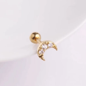 Close-up of golden crescent moon stud earring with tiny cubic zirconia and ball back