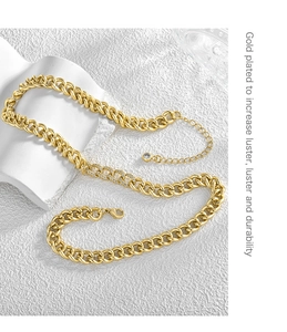 Macro shot of 18K gold-plated Cuban chain necklace with sparkling cubic zirconia accents