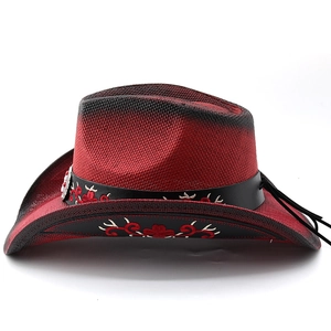 Detail of red and black gradient cowboy hat featuring floral embroidery on a leather band