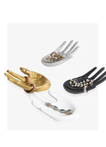 Detailed view of hand-shaped jewelry trays in gold, silver, black, and white colors