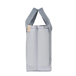 Side view of light blue canvas handbag showing thickness and sturdy fabric texture