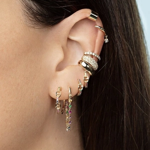 Rainbow cubic zirconia earrings set with gold hoops and ear cuffs on female model ear