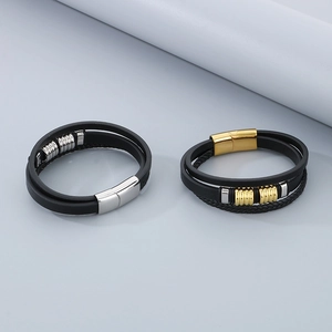 Detail of multi-layer woven leather bracelets with silver and gold magnetic clasps