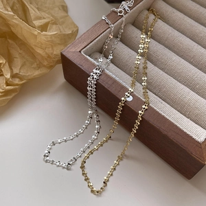 Detailed macro view of minimalist s925 silver star links chain in gold and silver finish