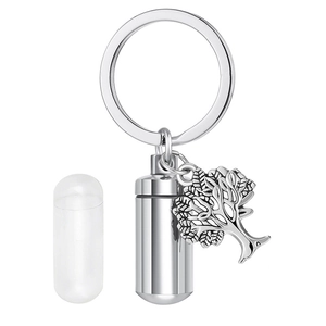 Detail of silver stainless steel cremation urn keychain with tree of life charm and inner capsule
