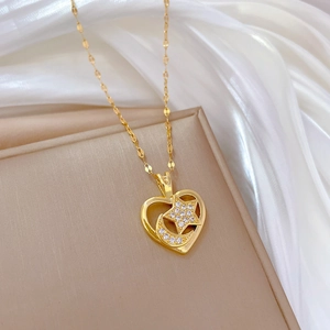 Elegant gold titanium necklace with heart-shaped pendant featuring moon and star zircon inlay