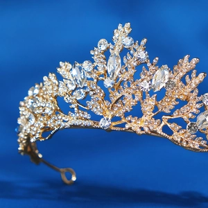 Elegant gold bridal tiara with sparkling crystal leaves on a luxury gradient blue background