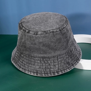 Detail showing the reinforced multi-row stitching on the brim of a washed denim bucket hat