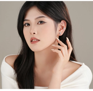 Close-up of S925 silver snowflake ear cuff with sparkling zircon stones on model ear