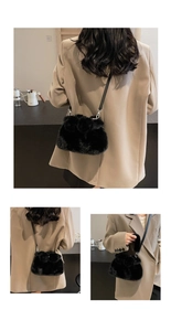 Detailed views of a black plush faux fur bucket bag with silver hardware on a model