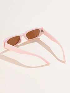 Detail shot of vintage rectangular pink sunglasses with dark brown lenses and thick frames