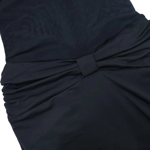 Detail of sheer mesh paneling and twisted knot design on this black bodycon dress