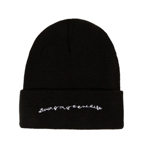 Black knit beanie with Living my best life white embroidery on a clean white background