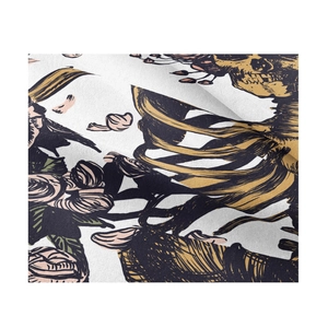 Close-up of printed fabric featuring golden skulls with black roses and floral patterns