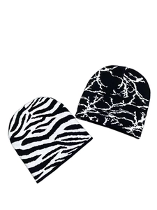 Detailed knit texture of black and white butterfly style beanies for men and women