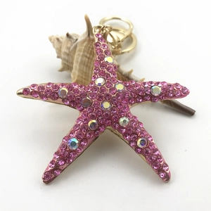 Detail of pink crystal starfish keychain with gold plating and rainbow rhinestones