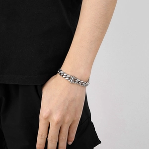 Close-up of 10mm silver stainless steel Cuban link bracelet on male model wrist