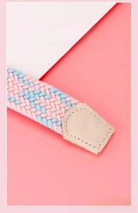 Detail of pink and blue woven elastic belt showing beige leather end and stitching