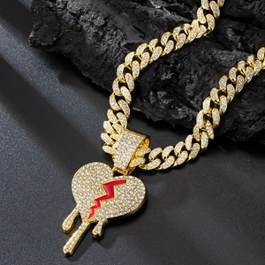 Hip hop golden Cuban link chain with a diamond encrusted bleeding broken heart pendant