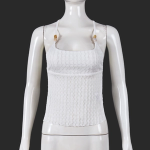 Detail of white halter neck top featuring textured pleats and wooden bead strap accents