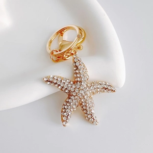 Close-up of golden starfish keychain with sparkling rhinestones and lobster clasp