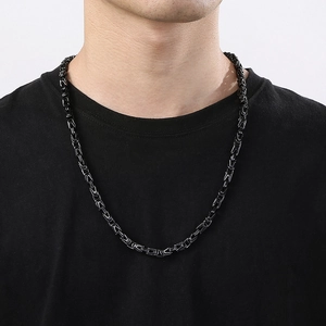 Close-up of a 6mm black stainless steel Byzantine chain necklace on a male model