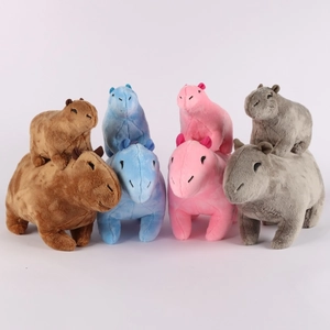 Group of plush Capybara toys in brown, blue, pink, and grey colors on white background