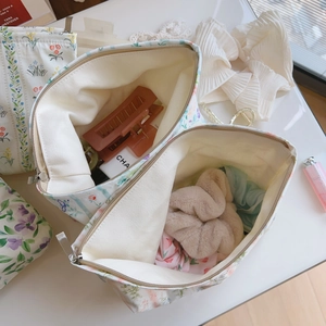 Detail view of floral print cotton makeup bags with zippers and high-capacity storage