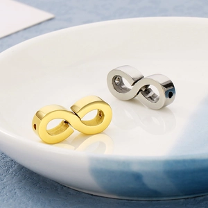 Close-up of gold and silver infinity symbol metal beads for DIY jewelry making
