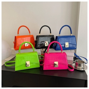 Detail shot of mini faux crocodile leather bags in five vibrant high-gloss colors