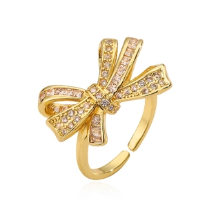Elegant gold-plated bow ring for women featuring sparkling cubic zirconia stones and open band