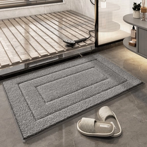 Absorbent gray rectangular bathroom mat with multi-layered border in a modern setting