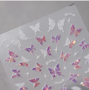 Detailed macro view of 3D embossed aurora butterfly nail stickers with white relief