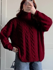 Detail of burgundy cable knit high neck zipper sweater with ribbed cuffs and hem