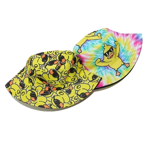 Close-up of double-sided sun hats featuring cartoon duck prints and rainbow tie-dye pattern