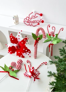 Detailed view of red and white striped Christmas candy cane picks for holiday tree decor