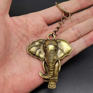 Vintage bronze elephant head keychain in hand showing metallic details and craftsmanship