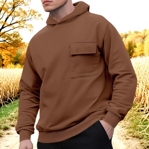 Men's brown casual fleece hoodie with front flap pocket against an autumn forest background