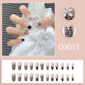 Faux ongles français élégants avec motif tweed et accessoires de nœud papillon 3D