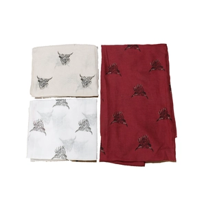 Detailed pattern of Highland cow print on soft winter scarves in beige, white and burgundy