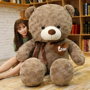 Macro detail of extra large brown teddy bear with plush texture and Love heart embroidery