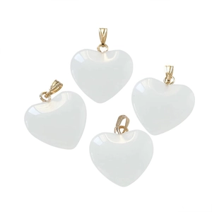 Macro view of four white translucent heart pendants with polished gold metal clasps