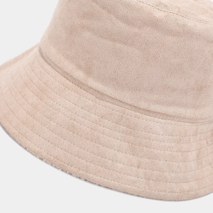 Macro shot of multi-row stitching on beige suede bucket hat brim showing fabric texture
